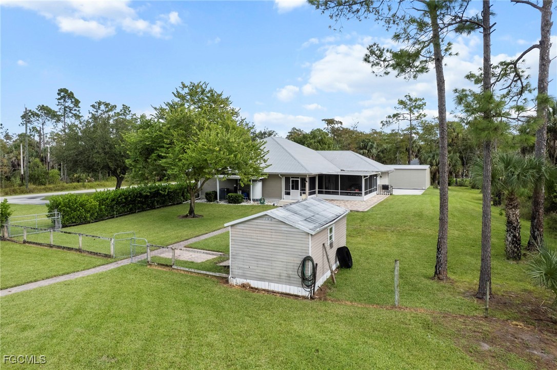 90 24th Avenue Northeast Naples, FL 34120 - Photo 25 of 44 a front view of a house with garden