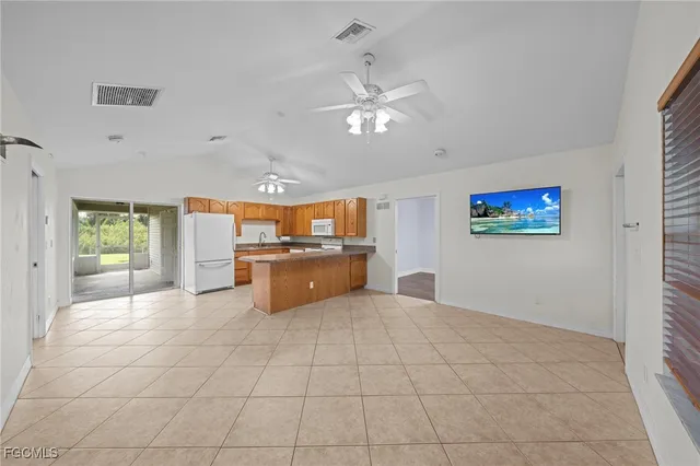 a kitchen with stainless steel appliances granite countertop a refrigerator and a sink