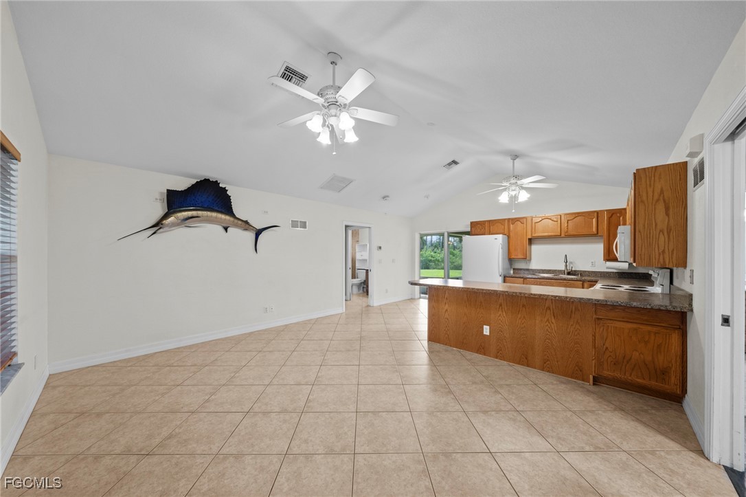 90 24th Avenue Northeast Naples, FL 34120 - Photo 28 of 50 a kitchen with stainless steel appliances granite countertop a refrigerator and a sink
