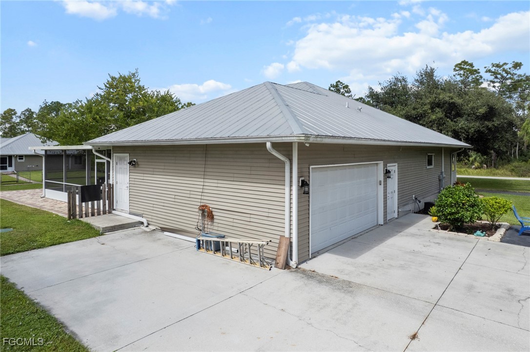 90 24th Avenue Northeast Naples, FL 34120 - Photo 29 of 44 a small white house with a white roof and wooden fence