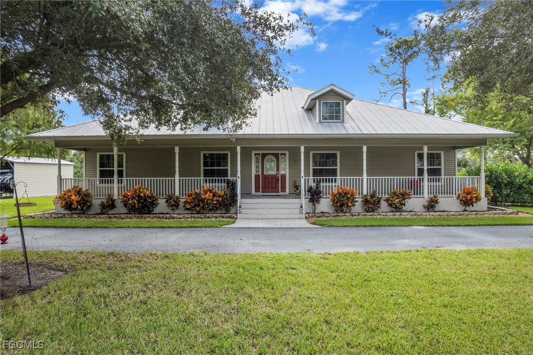 90 24th Avenue Northeast Naples, FL 34120 - Photo 30 of 50 a view of a house with a patio and a yard