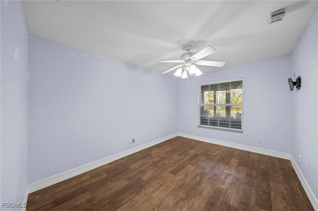 90 24th Avenue Northeast Naples, FL 34120 - Photo 35 of 50 an empty room with windows and chandelier fan