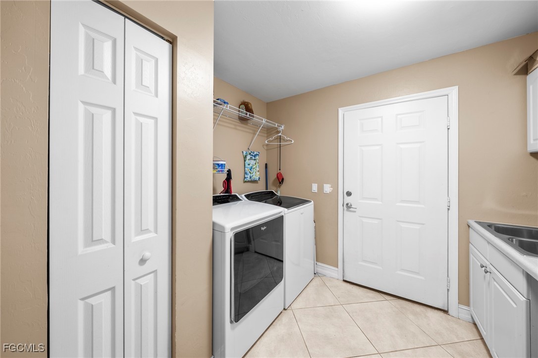 90 24th Avenue Northeast Naples, FL 34120 - Photo 39 of 50 a kitchen with white cabinets and white appliances