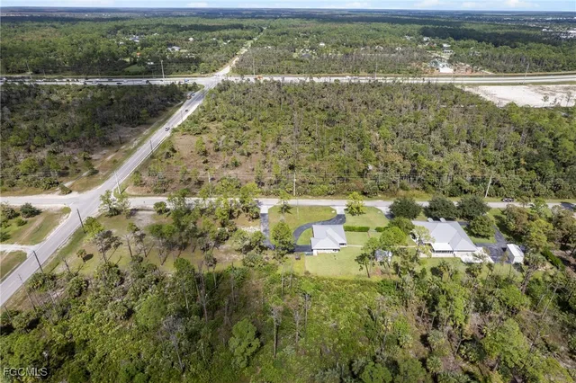 an aerial view of residential house with outdoor space and trees