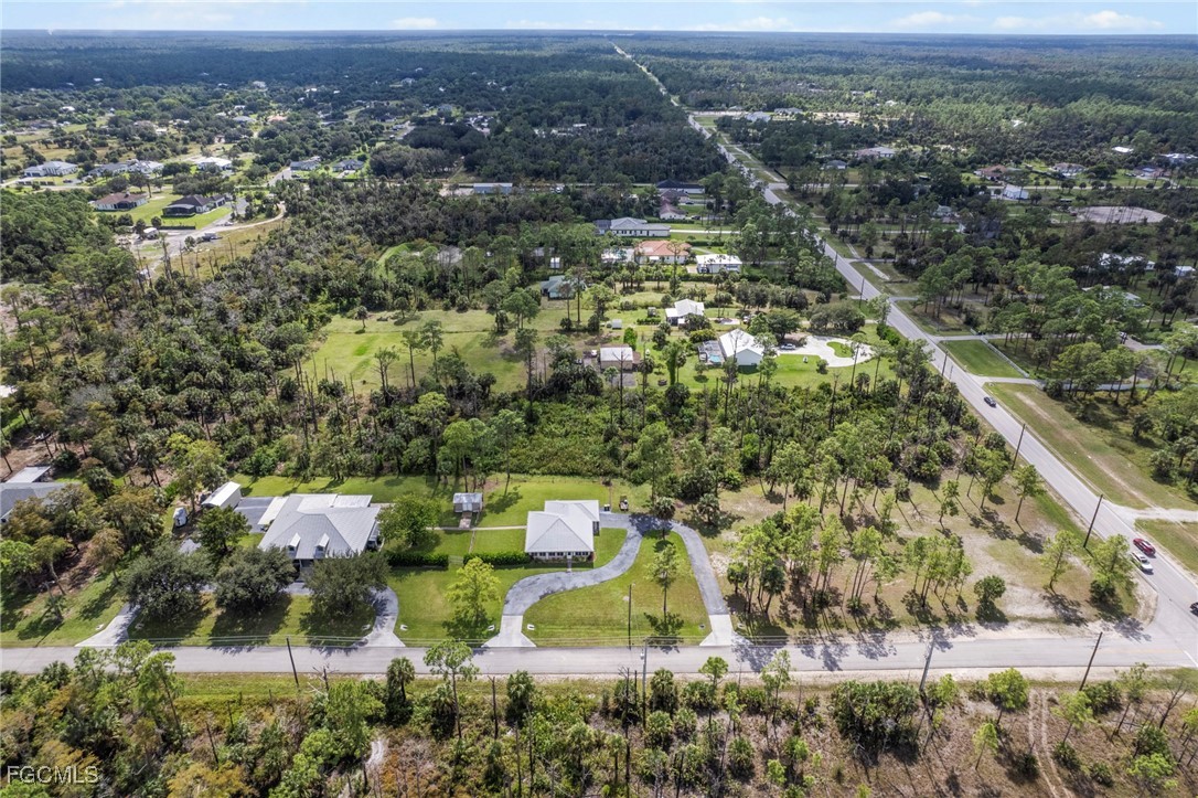 90 24th Avenue Northeast Naples, FL 34120 - Photo 46 of 50 an aerial view of residential house with outdoor space and trees