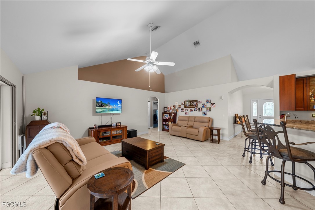90 24th Avenue Northeast Naples, FL 34120 - Photo 7 of 44 a living room with furniture and a chandelier