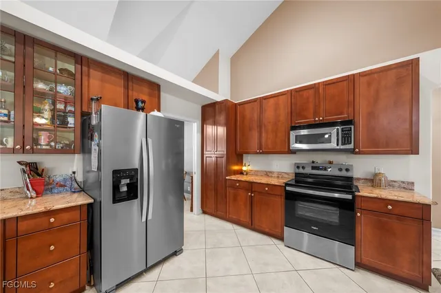 a kitchen with stainless steel appliances granite countertop a refrigerator stove and sink
