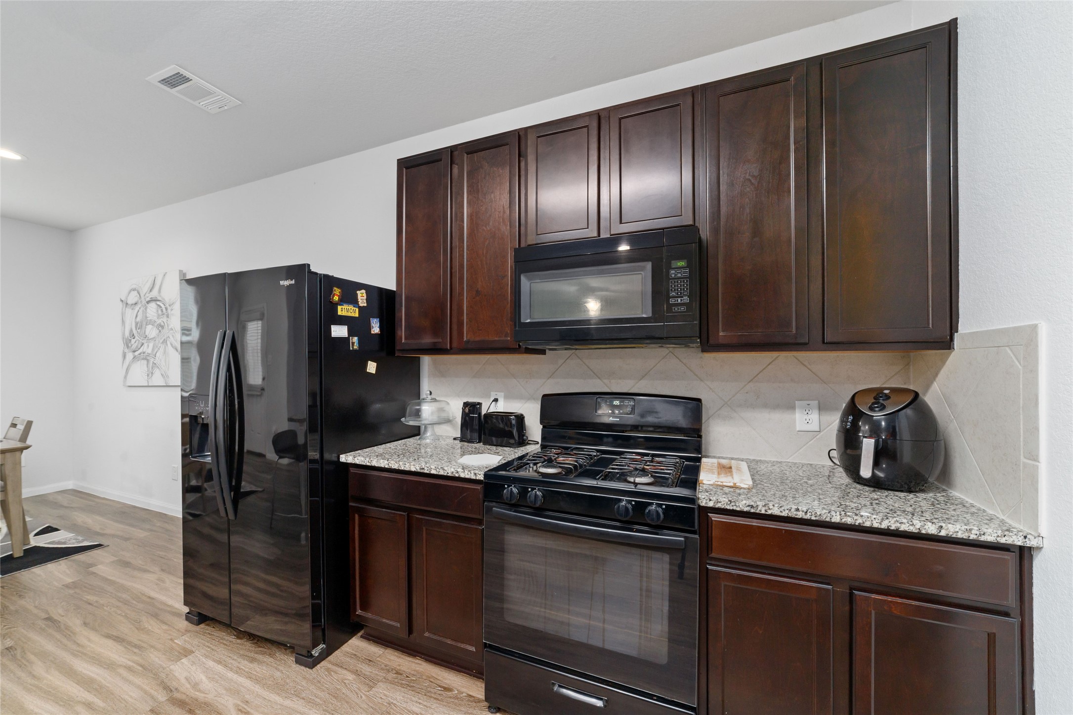 18619 Cooper Ravine Way Katy, TX 77449 - Photo 11 of 23 a kitchen with stainless steel appliances granite countertop a refrigerator and a stove top oven