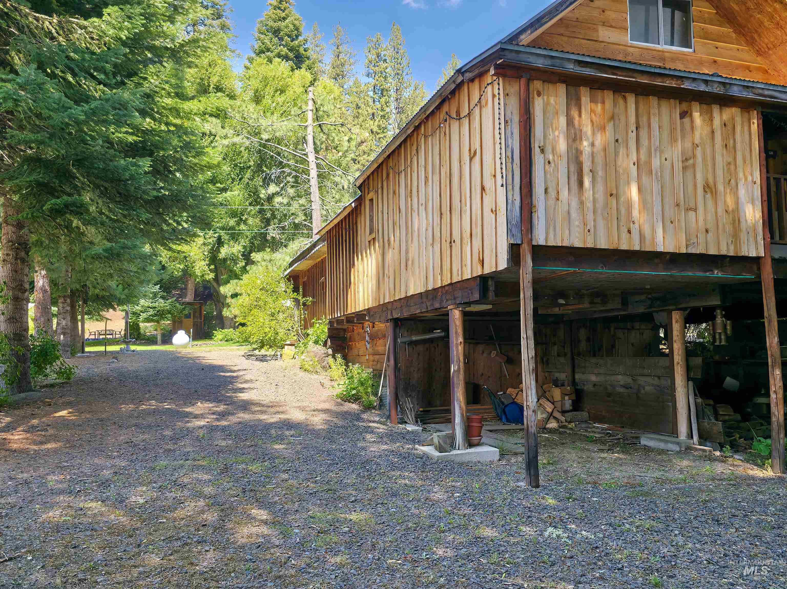 4482 Council Cuprum Road Council, ID 83612 - Photo 35 of 45 View of side of property with a forest view and an outdoor structure