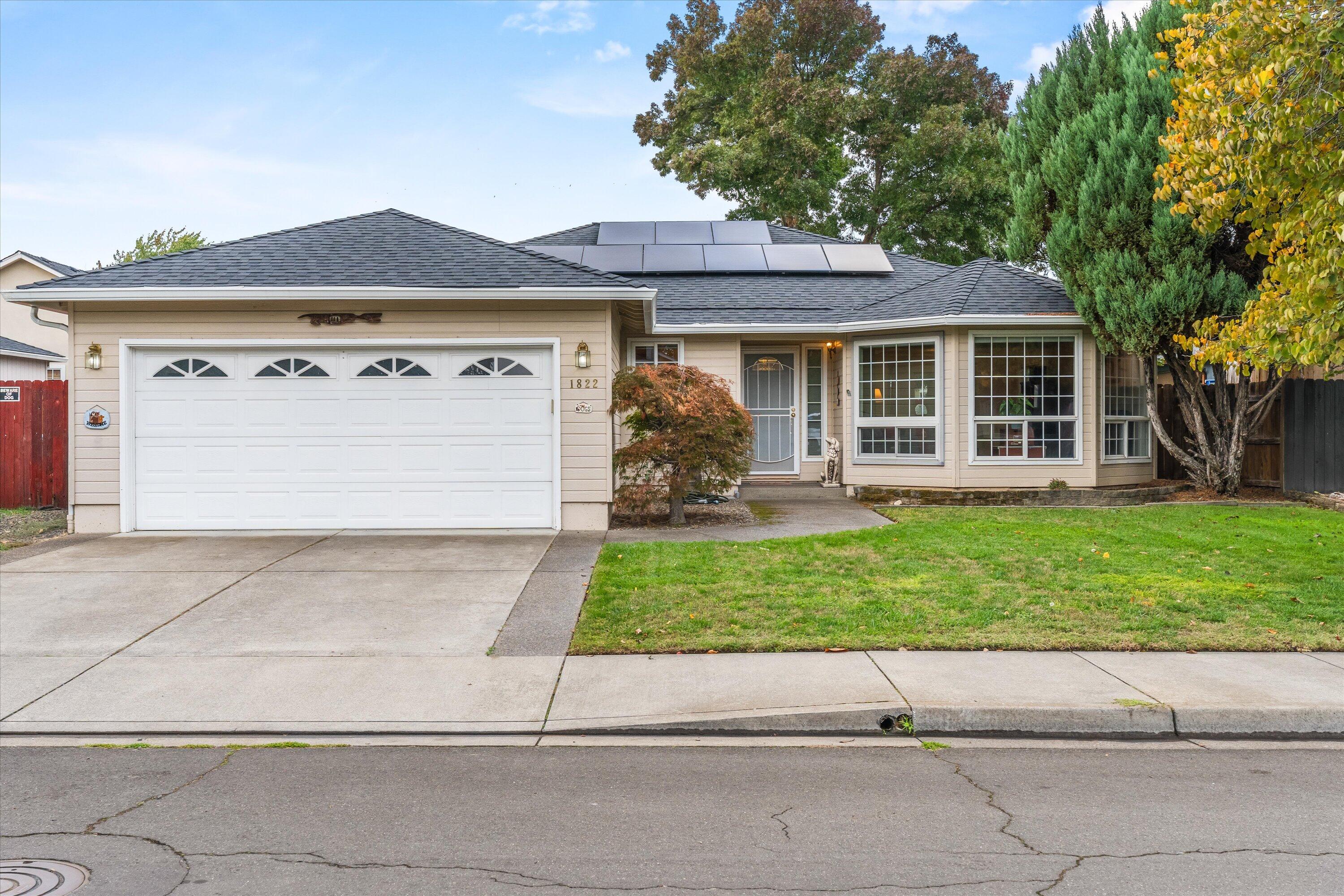 1822 Sarah Way Medford, OR 97501 - Photo 2 of 37 a front view of a house with a garden and trees