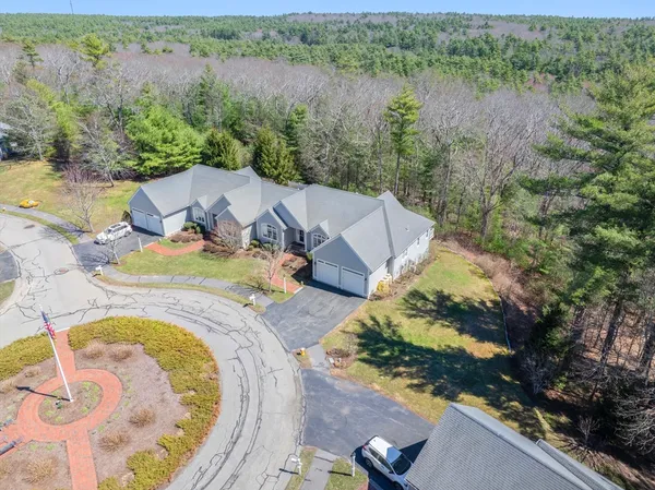 an aerial view of a house with outdoor space and lake view