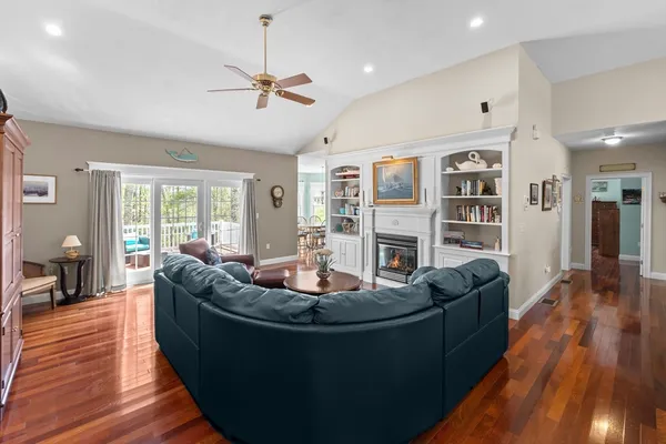a living room with furniture and a wooden floor
