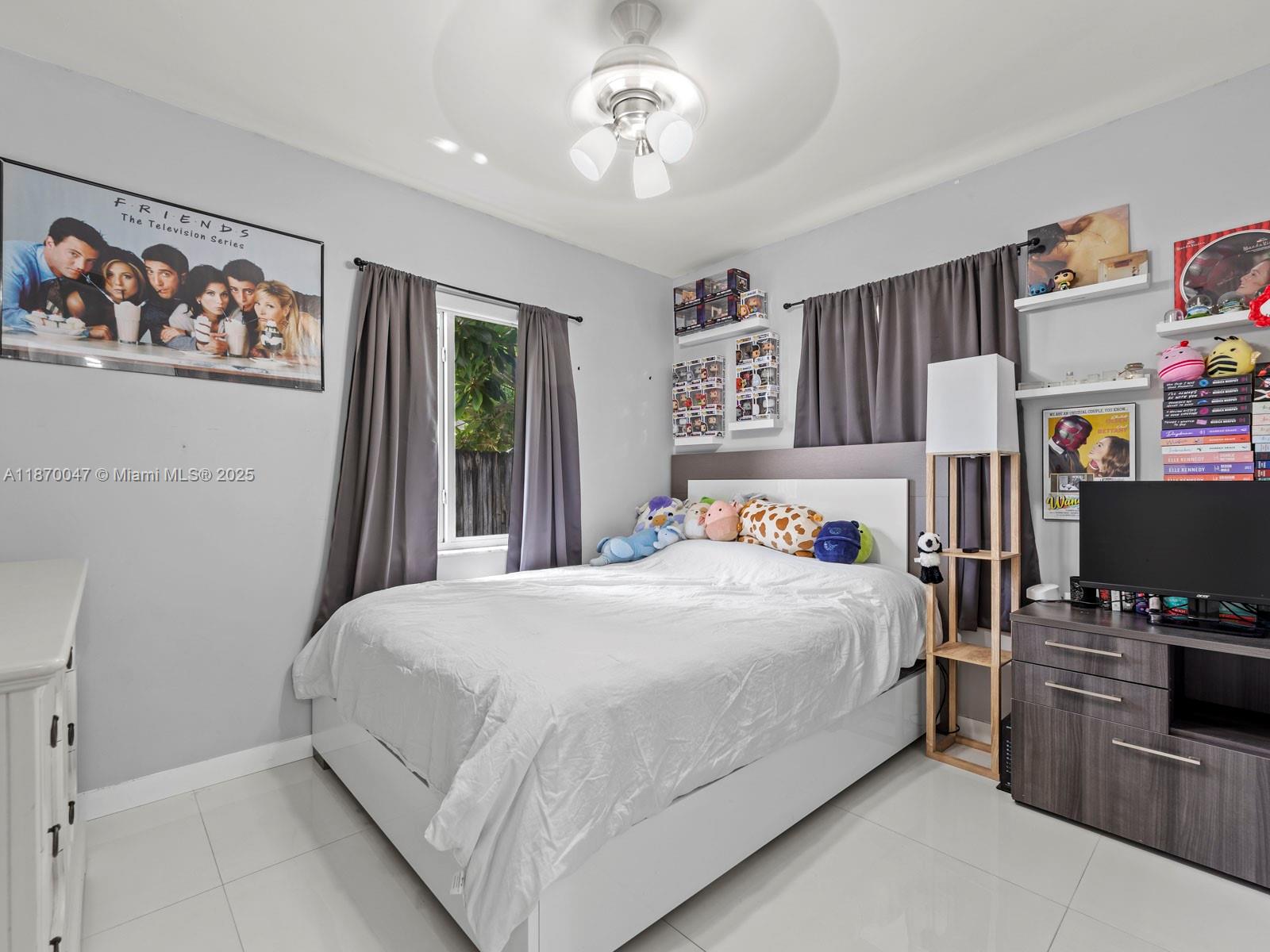 11350 Southwest 46th Street Miami, FL 33165 - Photo 12 of 20 a bedroom with a bed a computer on the desk and a window