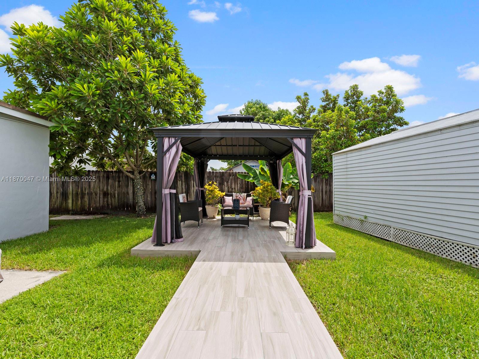 11350 Southwest 46th Street Miami, FL 33165 - Photo 16 of 20 a view of house with backyard swimming pool and sitting area
