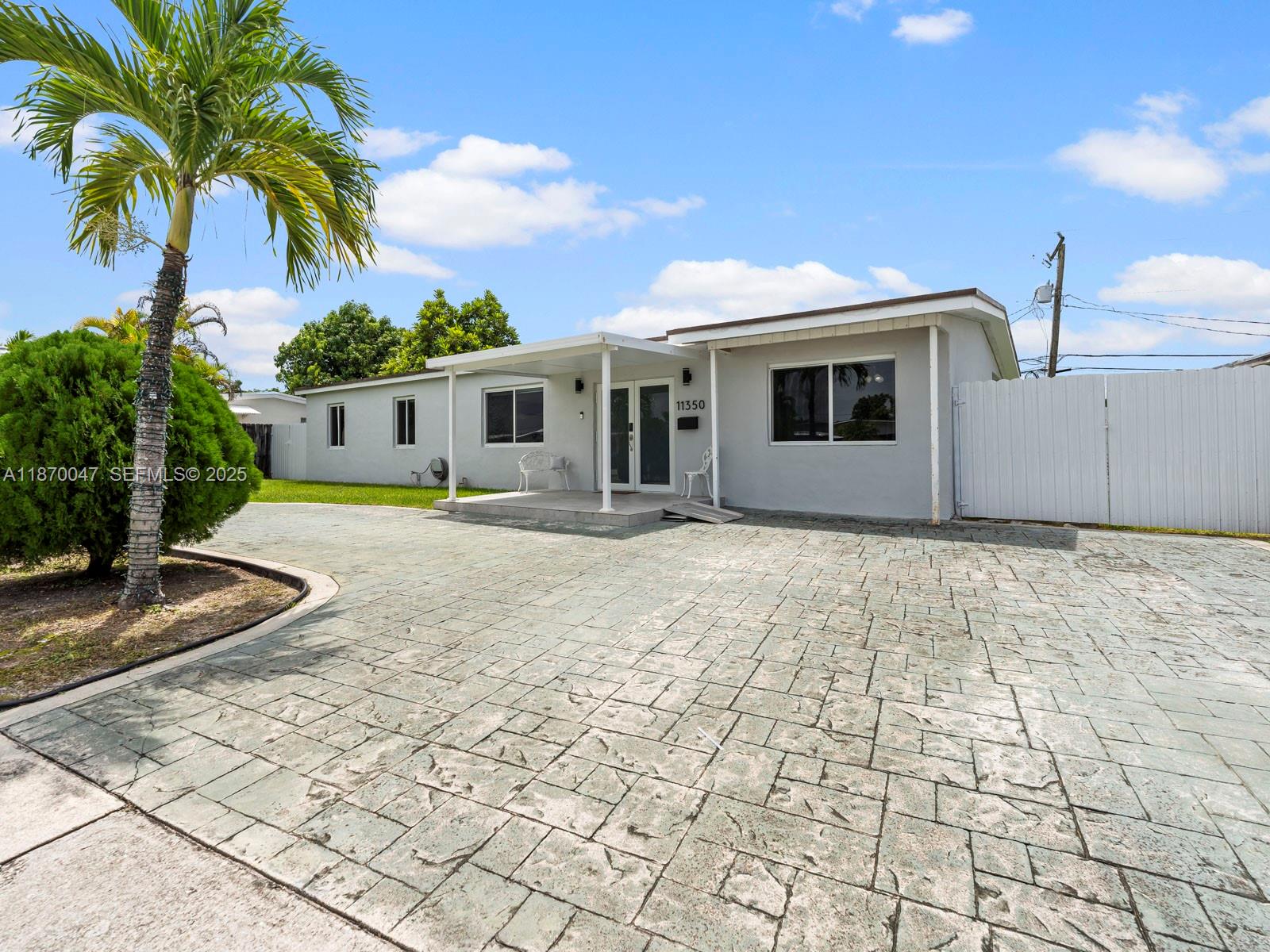 11350 Southwest 46th Street Miami, FL 33165 - Photo 2 of 20 a front view of a house with garden