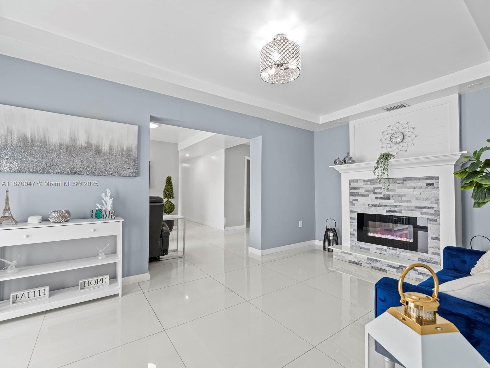 11350 Southwest 46th Street Miami, FL 33165 - Photo 4 of 20 a living room with furniture and a fireplace