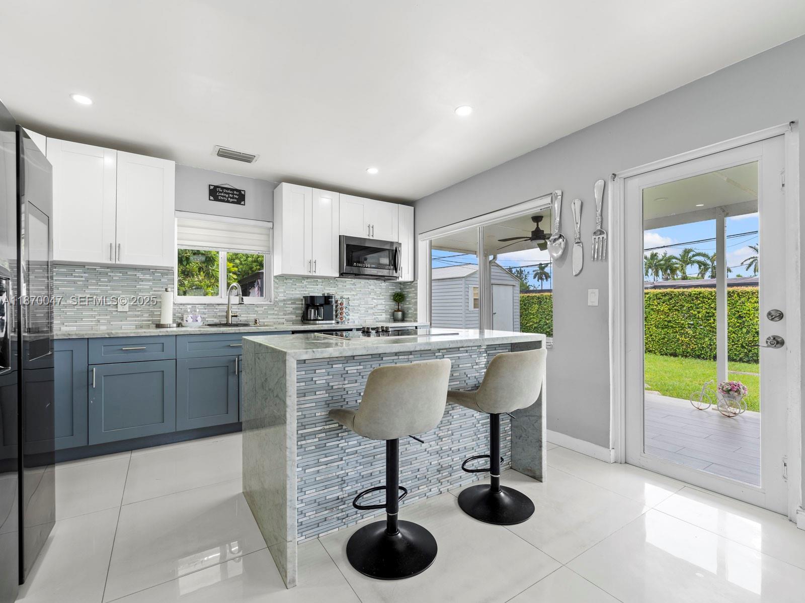11350 Southwest 46th Street Miami, FL 33165 - Photo 5 of 20 a kitchen with a sink cabinets and window