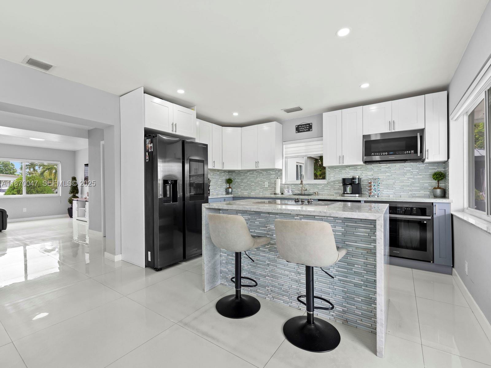 11350 Southwest 46th Street Miami, FL 33165 - Photo 6 of 20 a kitchen with stainless steel appliances granite countertop a refrigerator and a stove top oven