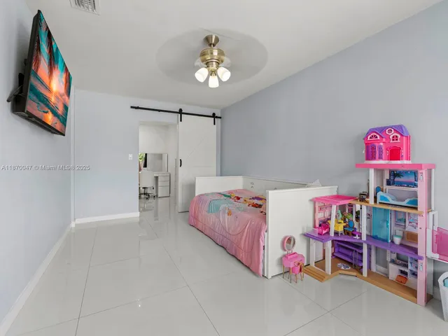 a bedroom with furniture and a chandelier