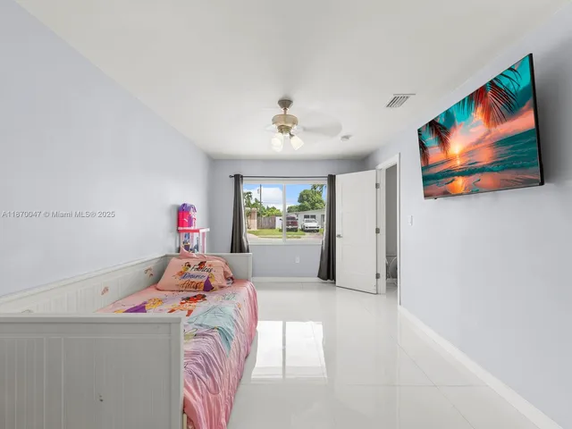 a bedroom with furniture and a chandelier