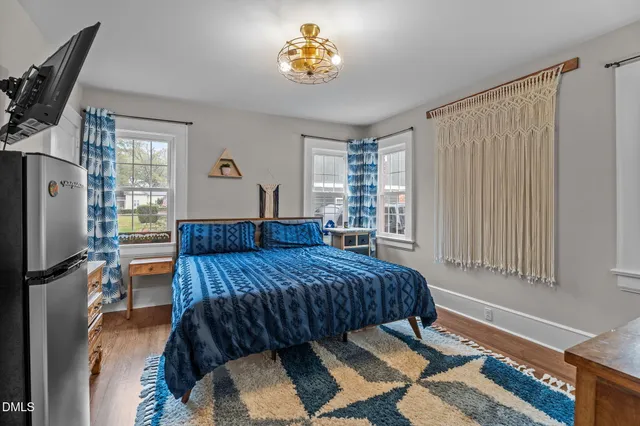 a bedroom with a bed and wooden floor