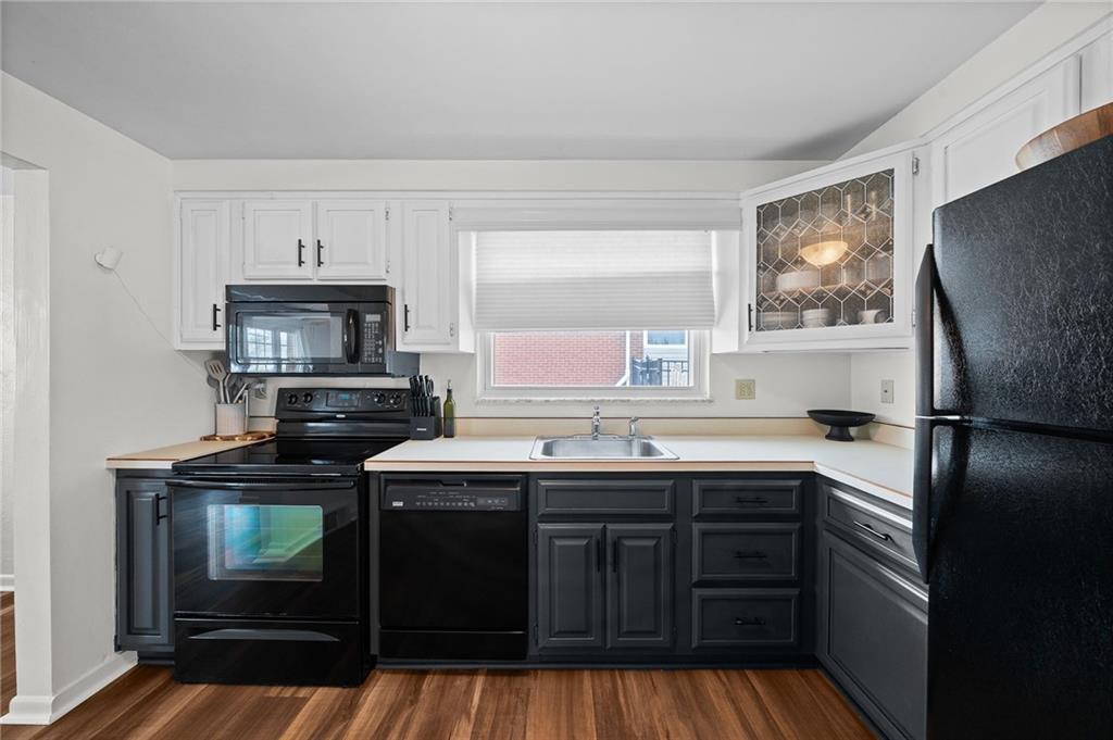 106 Windsor Drive Irwin, PA 15642 - Photo 11 of 30 Kitchen centered around a window above the sink, bringing in natural light and a bright, open feel.