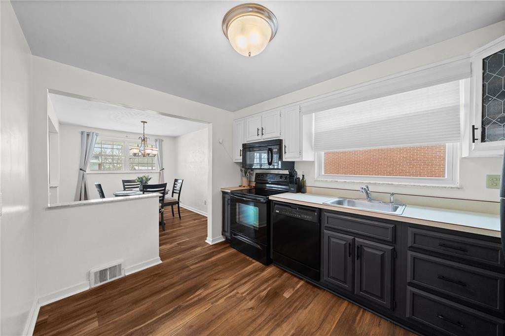 106 Windsor Drive Irwin, PA 15642 - Photo 12 of 30 Kitchen positioned just off the dining area with an easy connection to the three-season room.