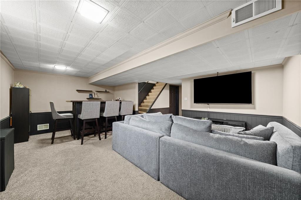 106 Windsor Drive Irwin, PA 15642 - Photo 24 of 30 Lower level designed for entertaining, offering room to gather and unwind.