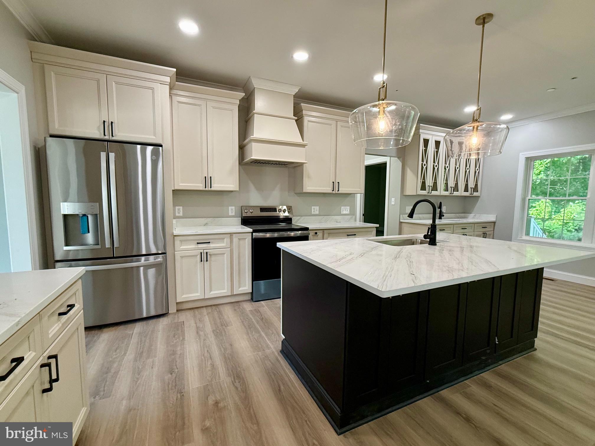 17480 Lighthouse Commons Drive Piney Point, MD 20674 - Photo 8 of 23 a kitchen with stainless steel appliances granite countertop a sink a stove and a refrigerator
