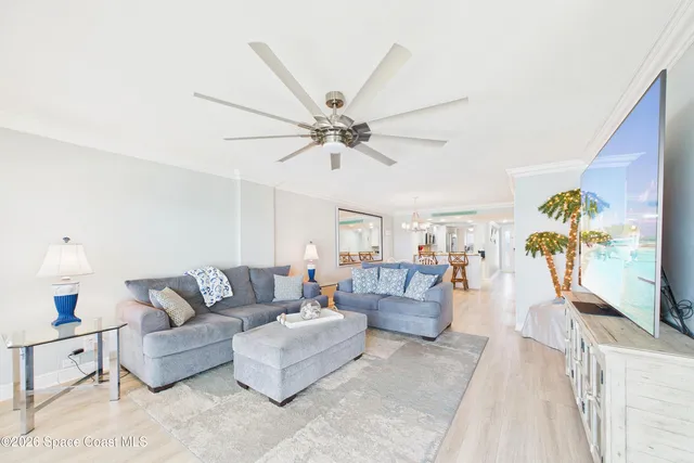 a living room with furniture and a floor to ceiling window