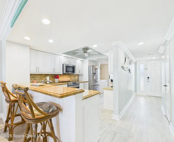 a kitchen with stainless steel appliances granite countertop a sink cabinets and a counter top space