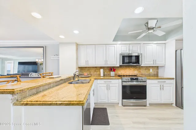 a kitchen with stainless steel appliances granite countertop a sink and cabinets