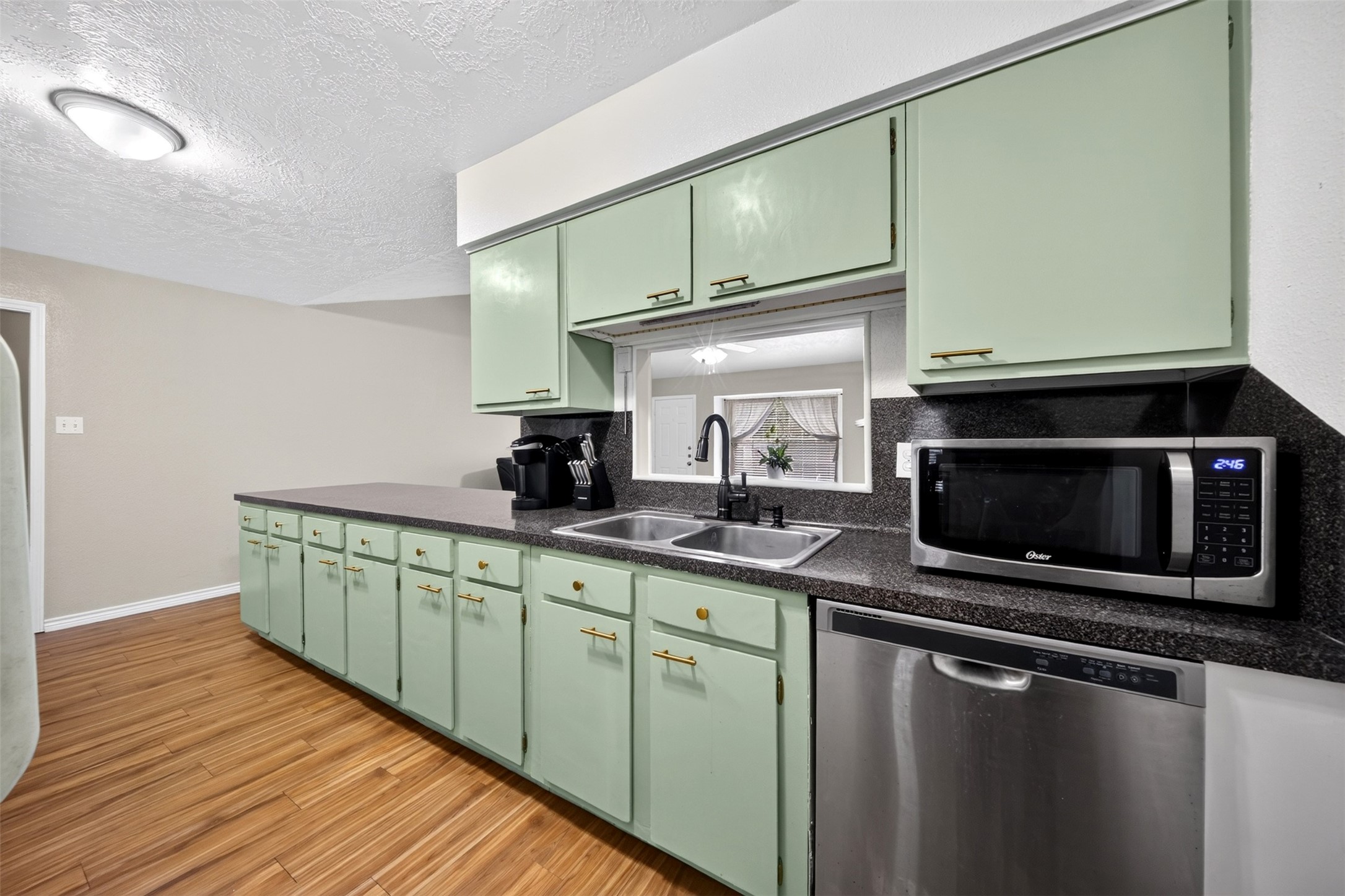 23127 Harpergate Drive Spring, TX 77373 - Photo 9 of 26 Bright kitchen features extensive cabinetry and convenient prep space.