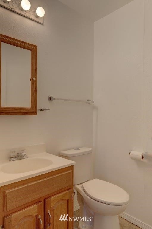 5711 Cady Road Everett, WA 98203 - Photo 7 of 15 a bathroom with a toilet a sink and mirror