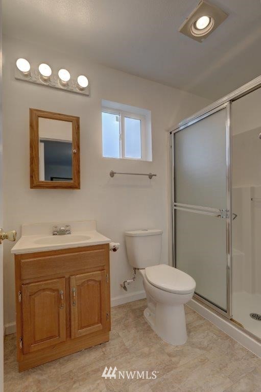 5711 Cady Road Everett, WA 98203 - Photo 9 of 15 a bathroom with a toilet a sink and mirror