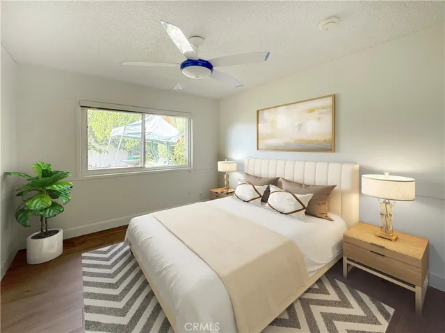 a bedroom with bed and a chandelier