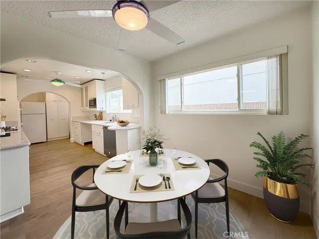 a view of a dining room with furniture and a potted plant