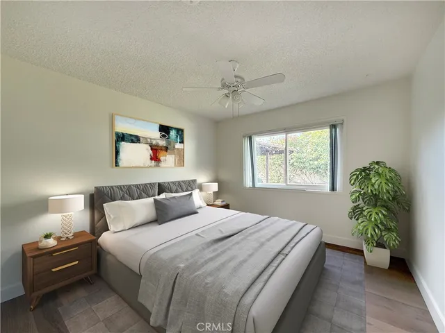 a bedroom with a bed and a potted plant