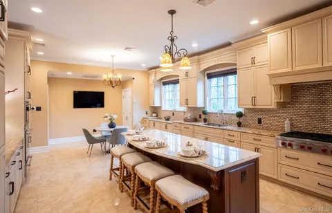 a large kitchen with a table and chairs in it