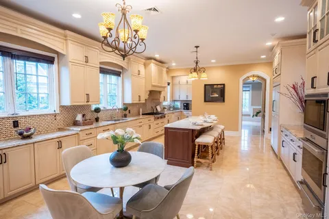 a large kitchen with a table and chairs