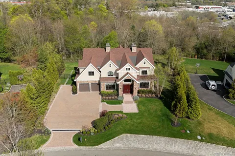 an aerial view of a house with a yard