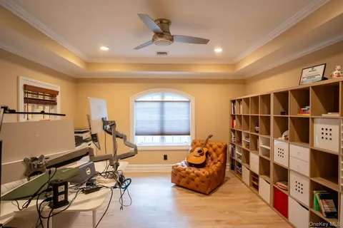 a living room with furniture gym equipment and a window
