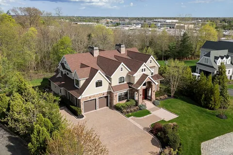 an aerial view of a house with a lake view