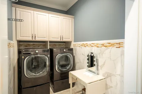 a view of a storage and utility room with washer and dryer