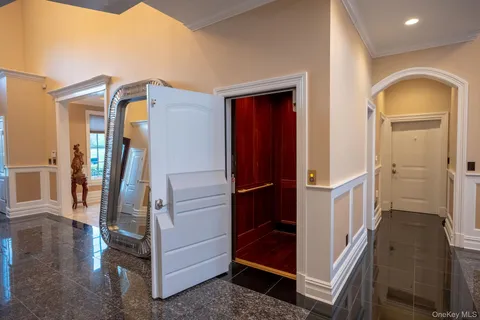 a view of hallway with stairs and wooden floor