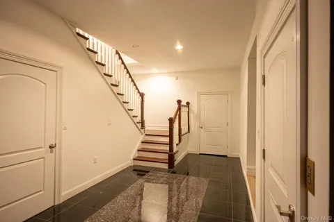a view of entryway with wooden floor and stairs