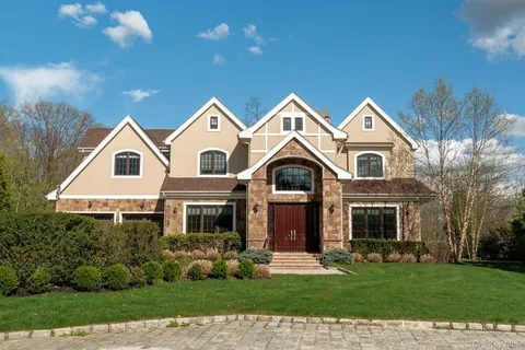 a view of house with yard and green space