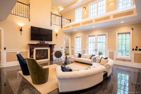 a living room with fireplace furniture and a flat screen tv