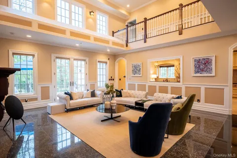 a living room with furniture rug and wooden floor