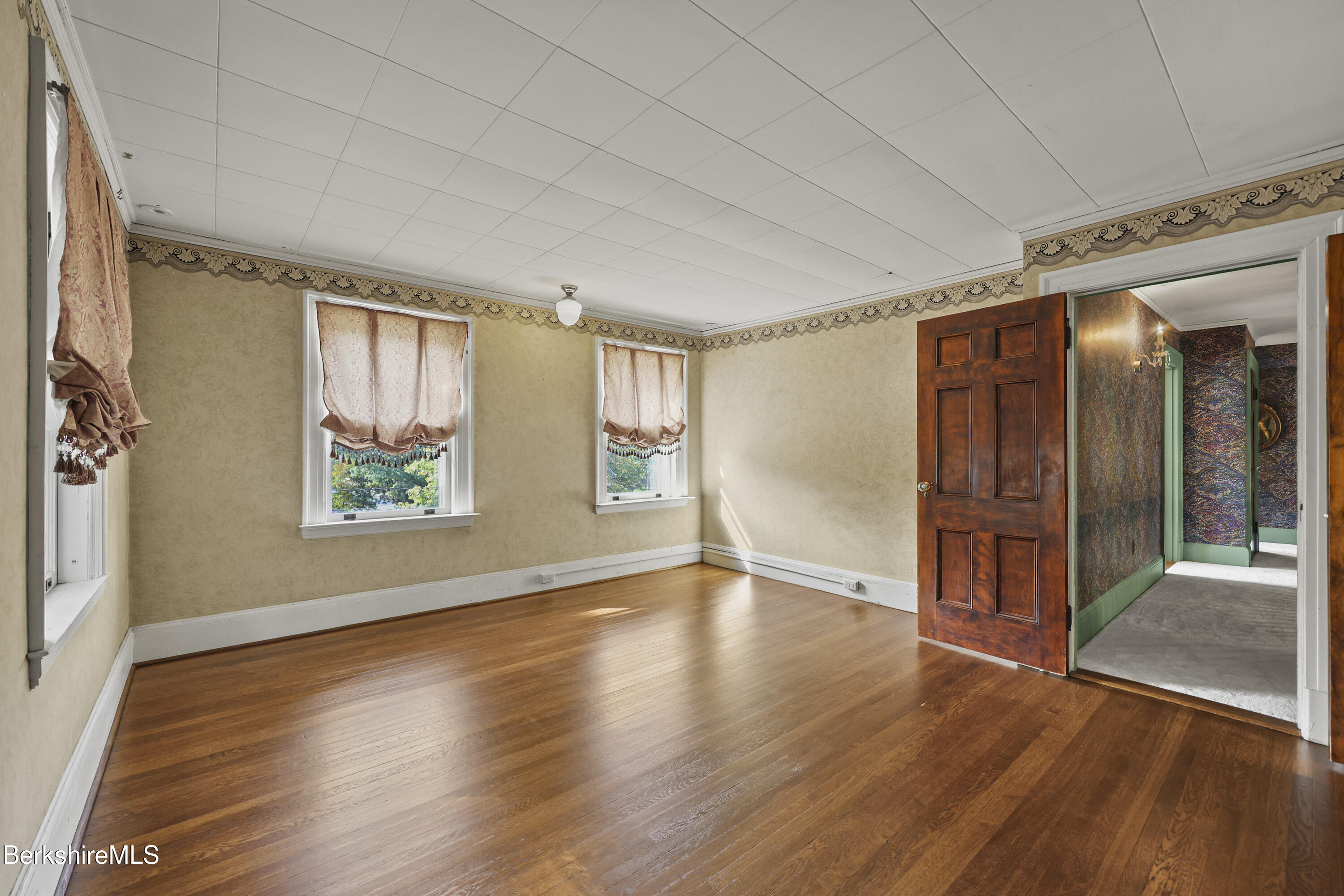 5 Crofut Street Pittsfield, MA 01201 - Photo 26 of 63 an empty room with wooden floor and windows